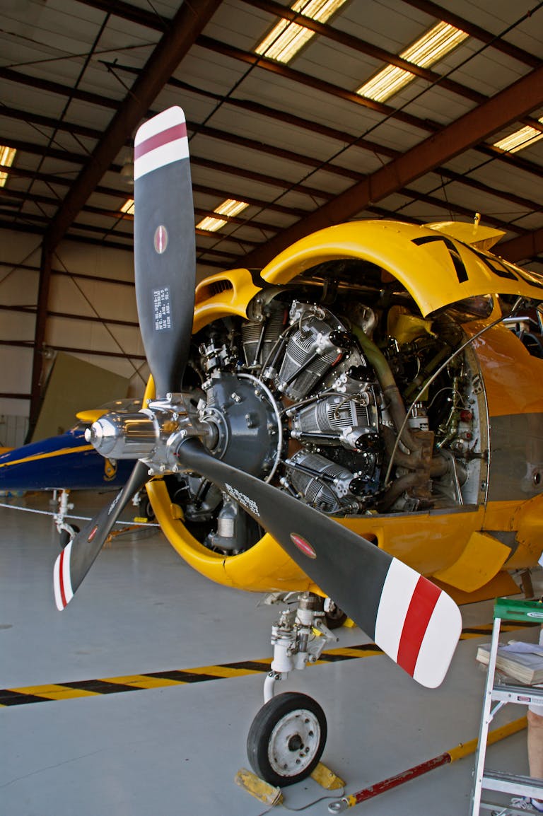 A vintage aircraft with an exposed radial engine inside a hangar in Titusville, Florida.